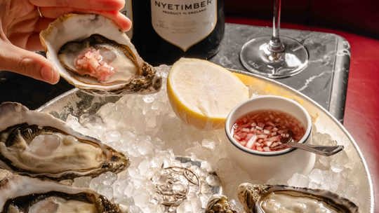 Oysters and champagne at Bentley's Oyster Bar & Grill seafood restaurant in Mayfair, London