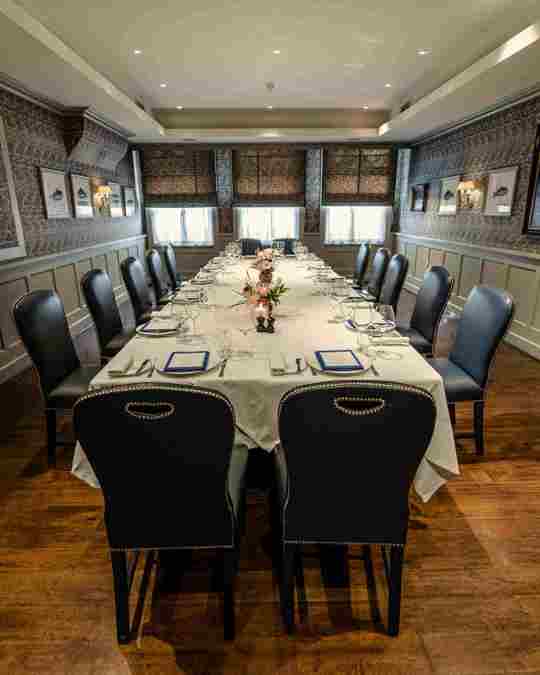 Intimate dining setup with white tablecloths and elegant decor at Bentley’s Oyster Bar, a top fish restaurant in Mayfair.